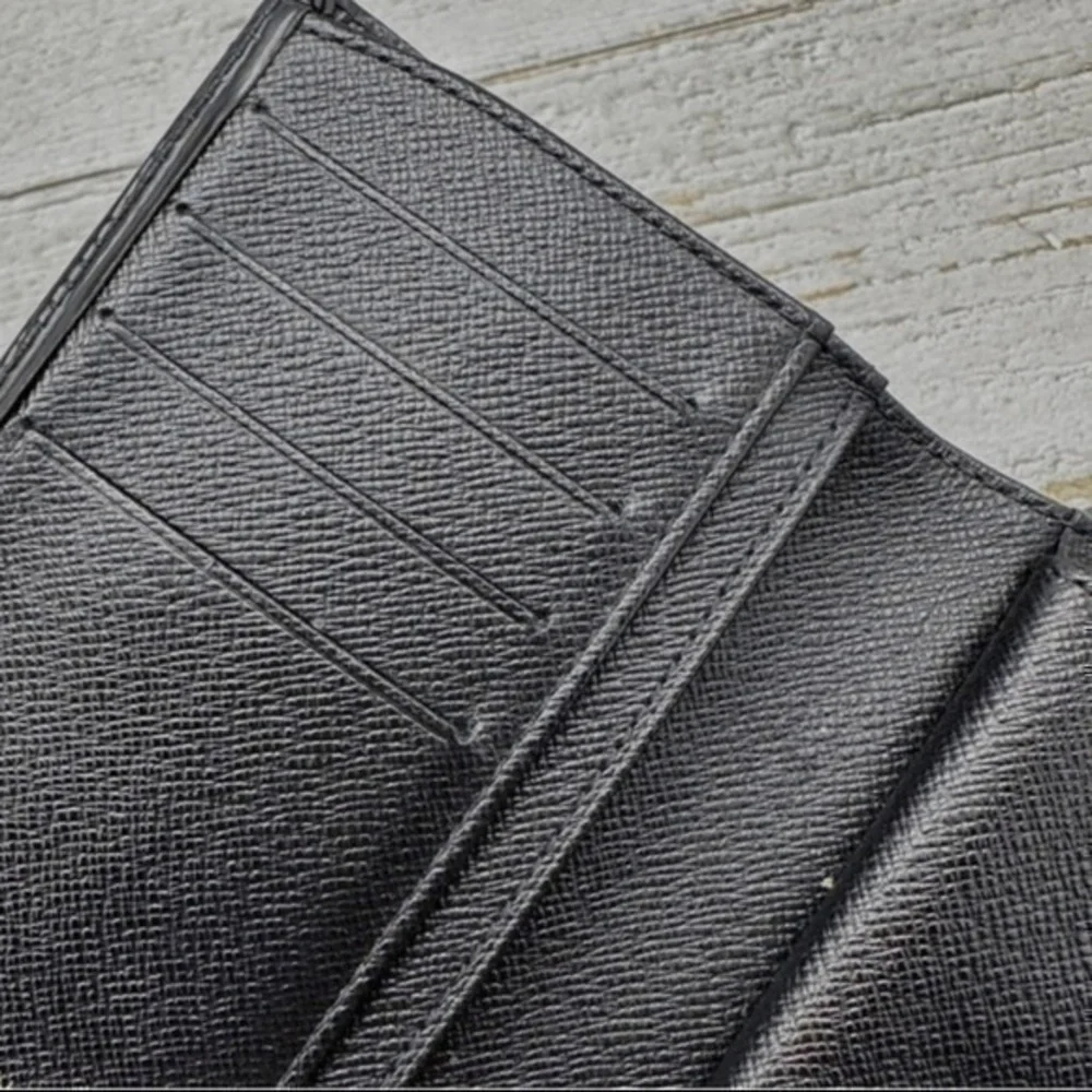 AUTHENTIC Louis Vuitton Taiga wallet. Previously owned. Color: Black.